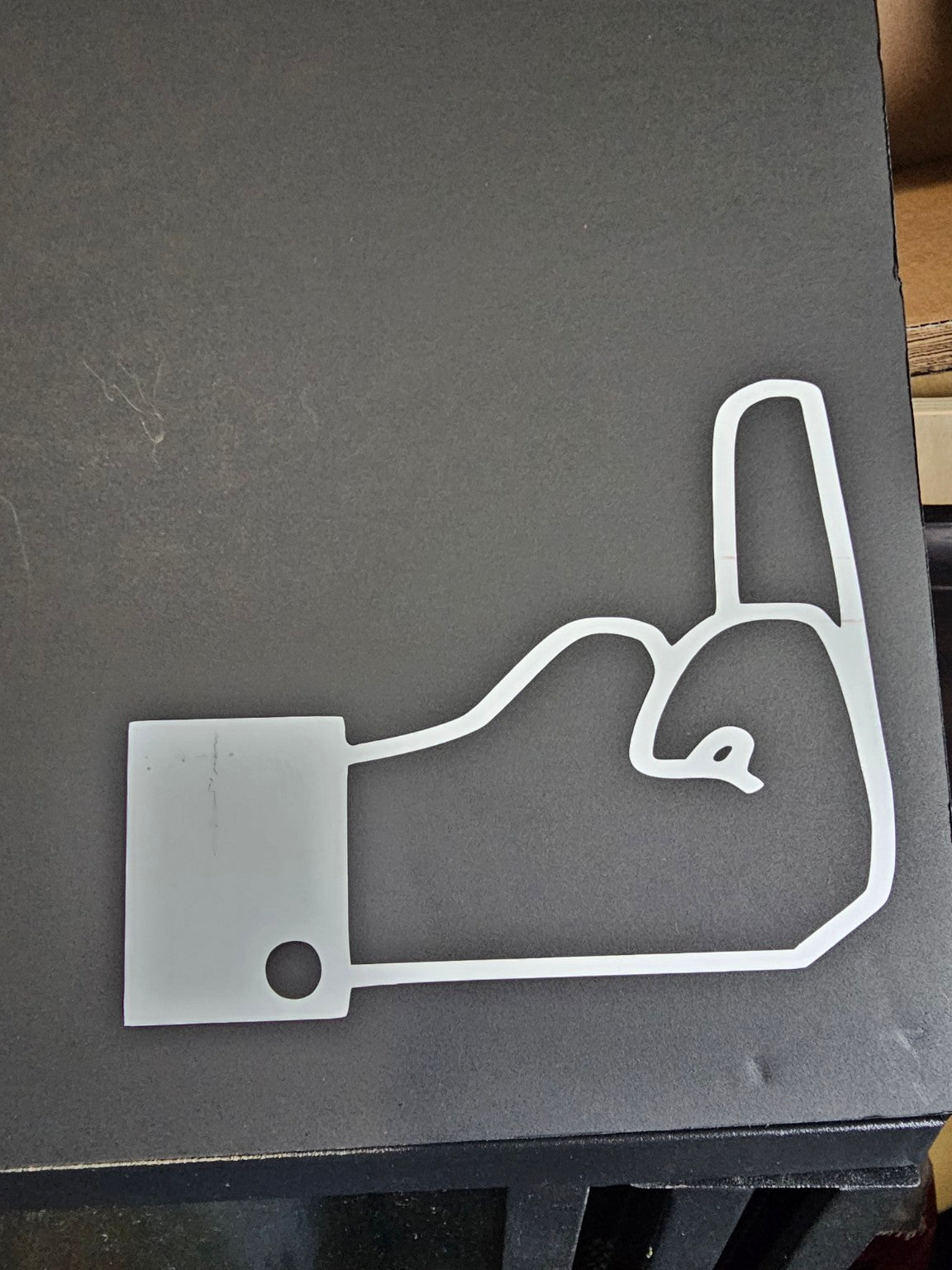 White Facebook opinion button vinyl decal displayed on black board