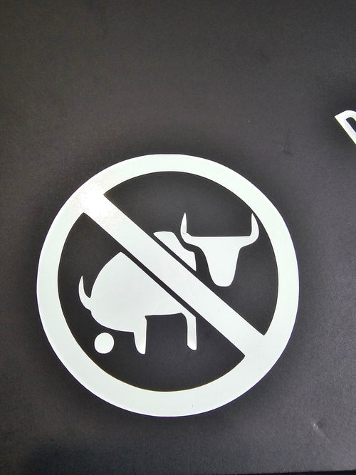 White No Bullshit prohibition-symbol vinyl decal displayed on black board